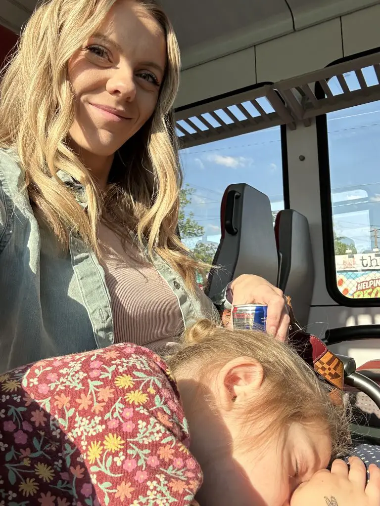 Mom and daughter on train from downtown austin to kramer