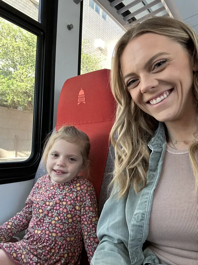 mother and daughter on a train to kramer station things to do in austin with toddlers